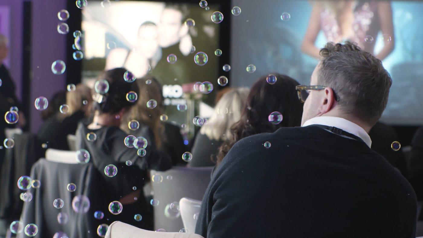 Soap bubbles drifting over the audience at a launch evening