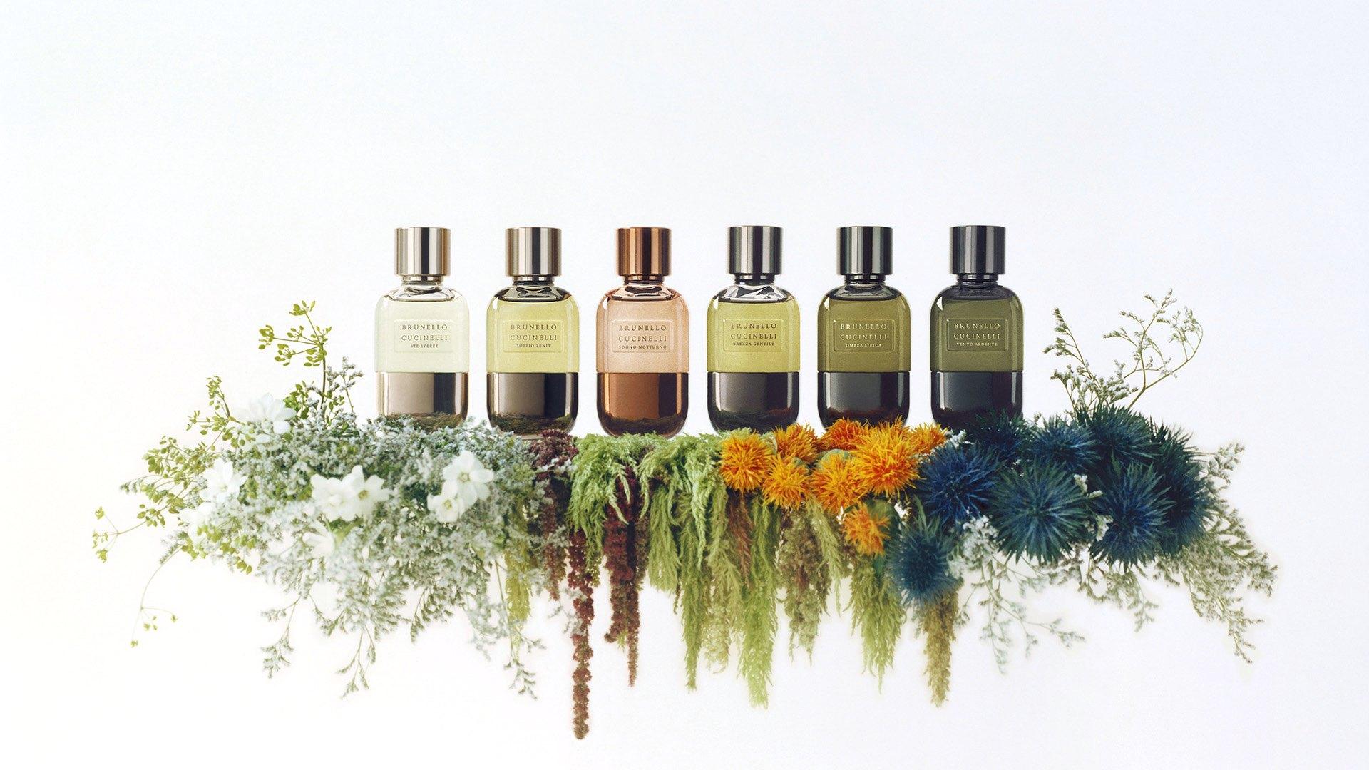 Six Brunello Cucinelli fragrances above a bank of wild flowers
